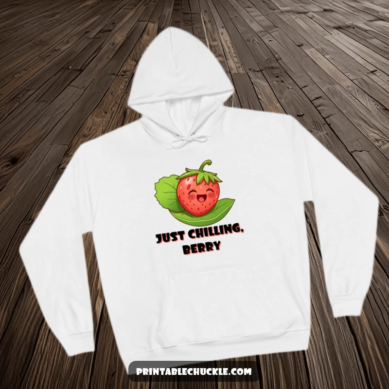 Funny, warm hoodie depicting a delighted strawberry serenely floating on its leaf, offering a comforting and cheerful aesthetic.