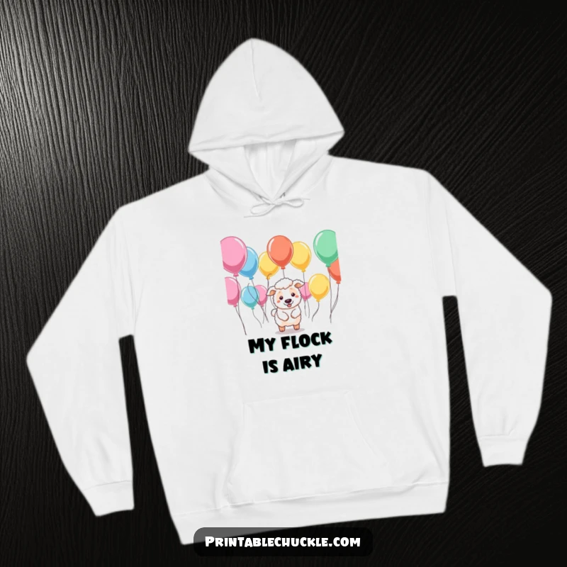 Funny hoodie depicting a sheepdog trying to herd floating balloons, offering warmth and a touch of hilarious, chaotic energy.