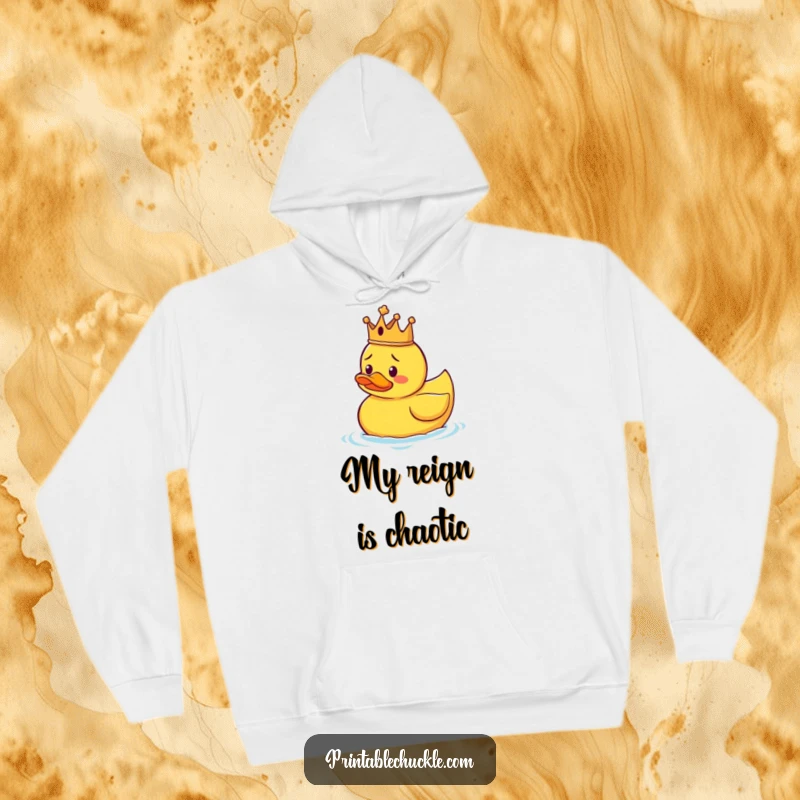 Funny hoodie depicting a rubber duck wearing a small crown, floating uncertainly, providing warmth and a touch of regal absurdity.
