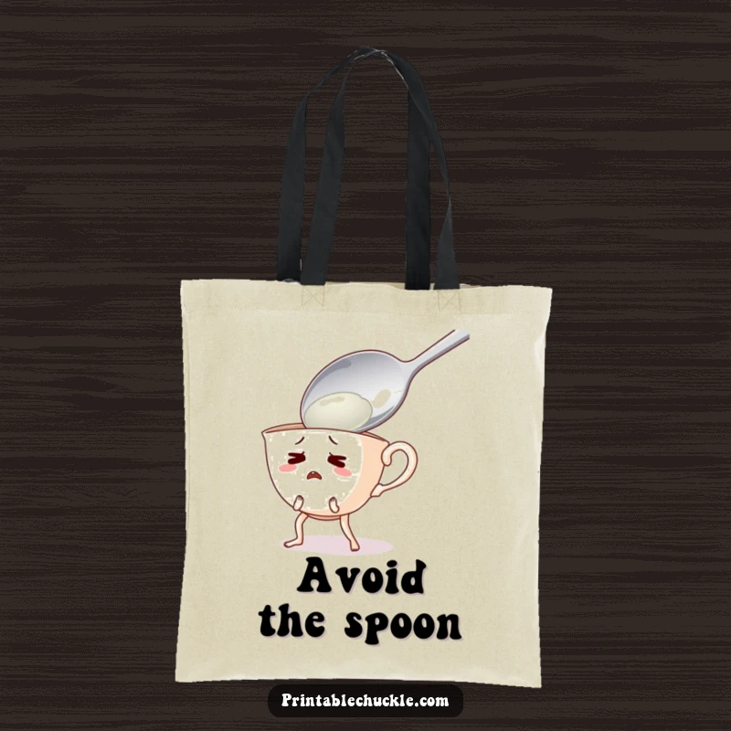 Funny tote bag showing a startled teacup with legs running from a giant spoon, a humorous everyday carry-all.